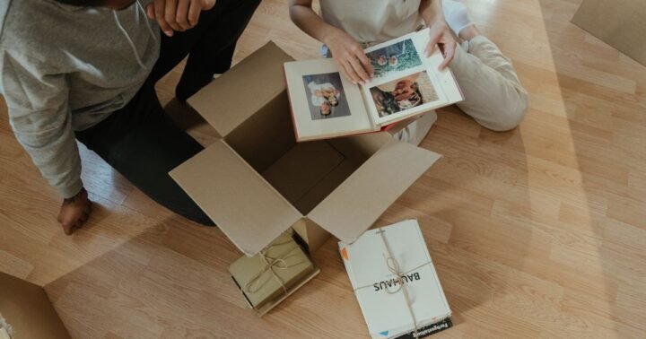 Sell inherited house in Texas – family photo albums being unpacked from a moving box