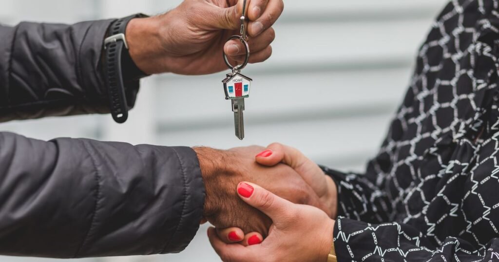 Texas real estate closing process – handshake and house keys exchanged at closing