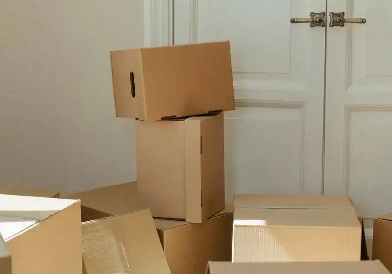Sell my house fast when relocating – moving boxes stacked beside a door