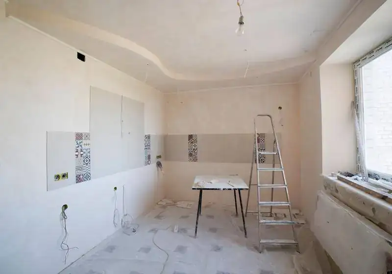 Sell house needing repairs Texas – room under renovation with a ladder and work table